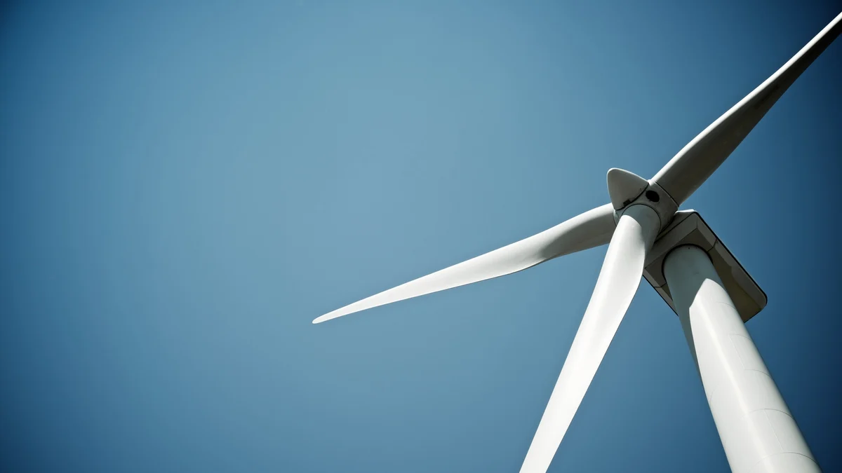 Wind turbine blades viewed against the sky