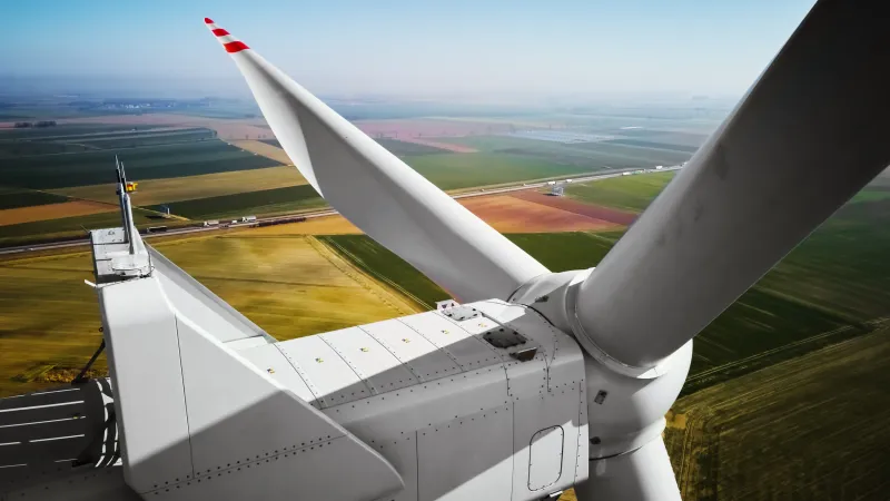 Technician inspecting a wind turbine blade